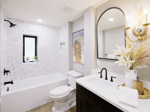 A bathroom remodel that includes a show and granite countertop sink. 